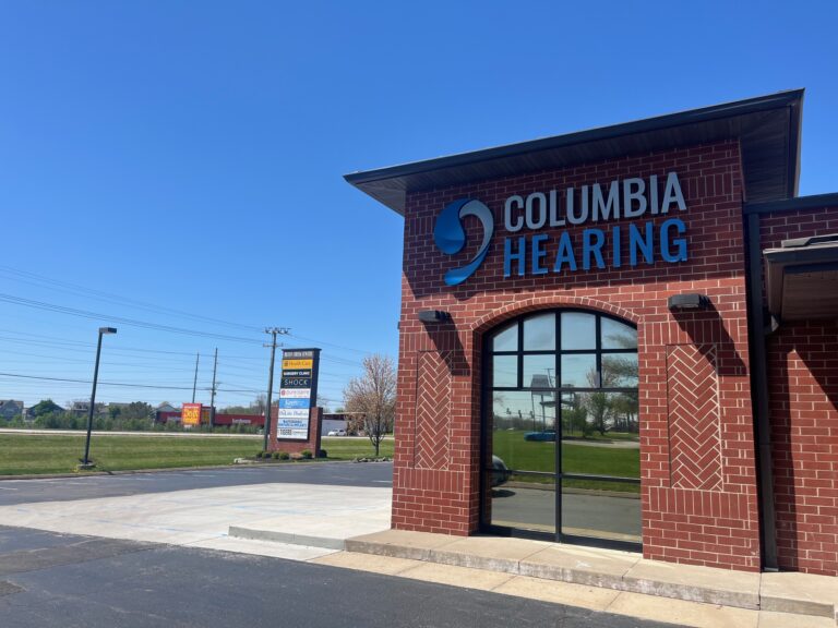 View of Columbia Hearing Center building from the side, with Bluff Creek Center sign in the background